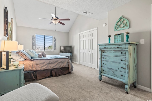 carpeted bedroom with baseboards, visible vents, vaulted ceiling, a textured ceiling, and a closet