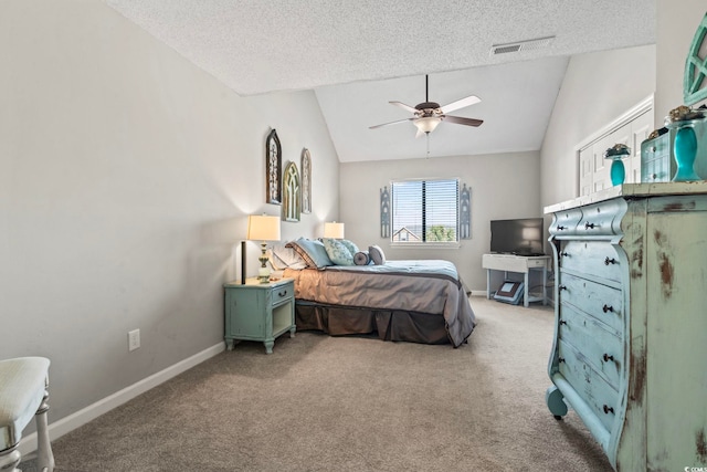 carpeted bedroom featuring vaulted ceiling, a textured ceiling, baseboards, and ceiling fan