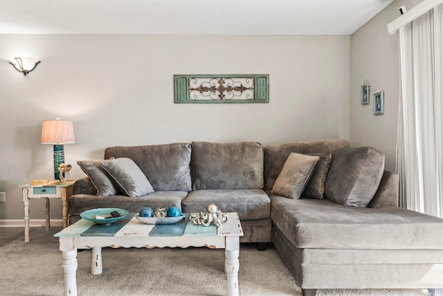 carpeted living room with baseboards