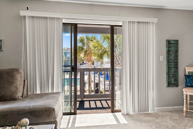 doorway featuring carpet floors and baseboards