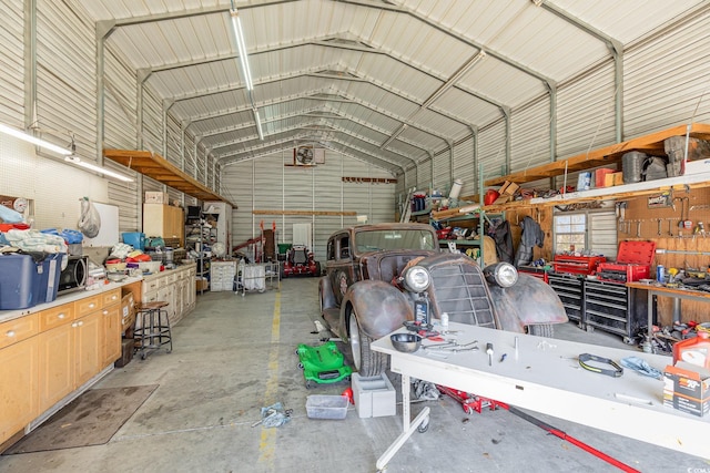 garage featuring a workshop area and metal wall