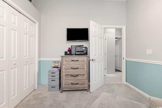 interior space with baseboards and light colored carpet