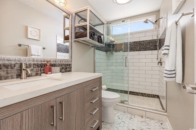 bathroom with backsplash, toilet, a shower stall, vanity, and tile patterned floors