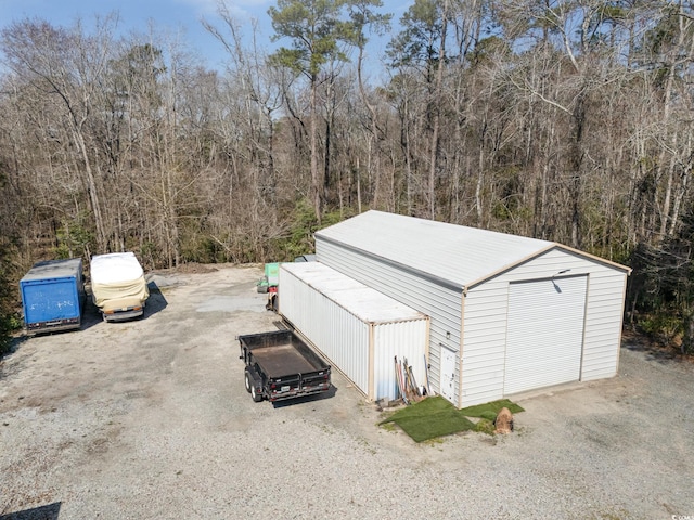 exterior space featuring a wooded view