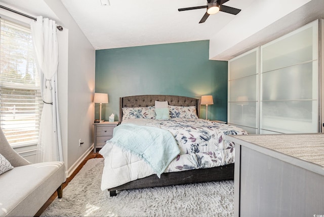 bedroom with vaulted ceiling, baseboards, and ceiling fan