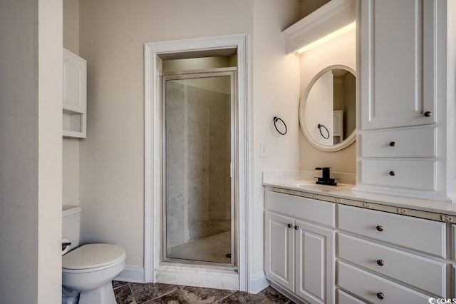 full bath featuring vanity, baseboards, a shower stall, and toilet