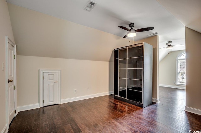 bonus room featuring ceiling fan, visible vents, baseboards, wood finished floors, and vaulted ceiling
