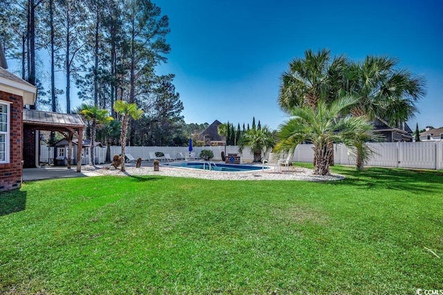 view of yard featuring a fenced in pool, a fenced backyard, and a patio area