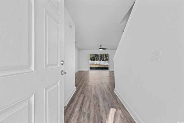 hallway with wood finished floors and baseboards