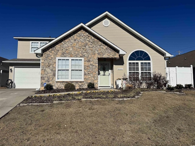 ranch-style home featuring fence, stone siding, a garage, and concrete driveway