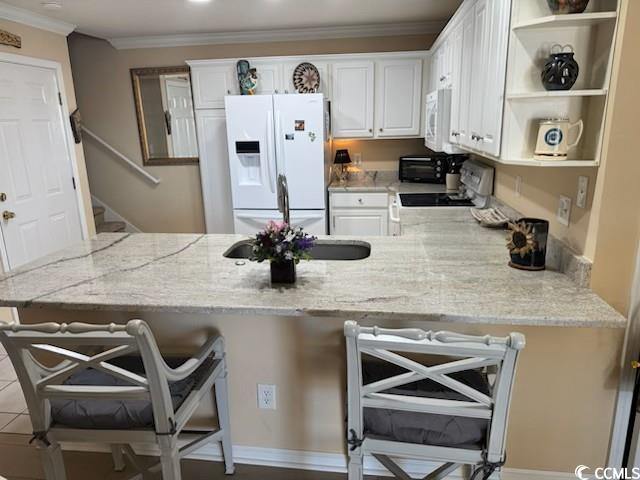 kitchen featuring ornamental molding, a peninsula, white appliances, white cabinetry, and open shelves