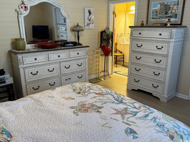 bedroom featuring light wood-style floors and baseboards