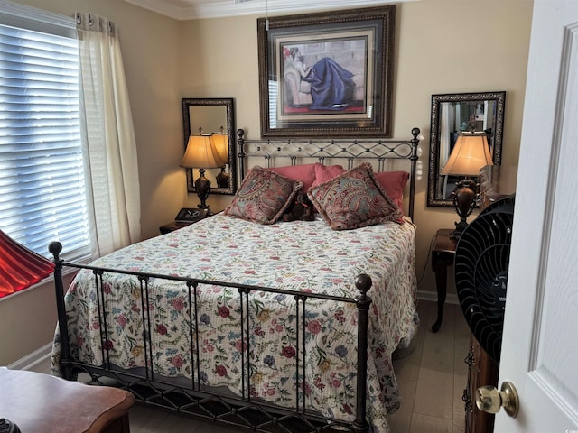 bedroom with baseboards and crown molding