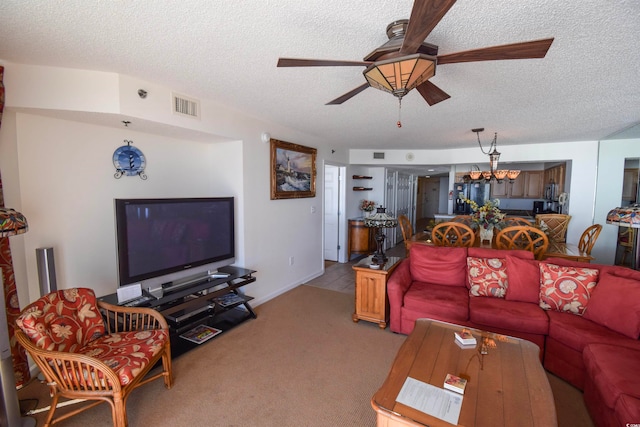 living area featuring ceiling fan with notable chandelier, light colored carpet, visible vents, and a textured ceiling