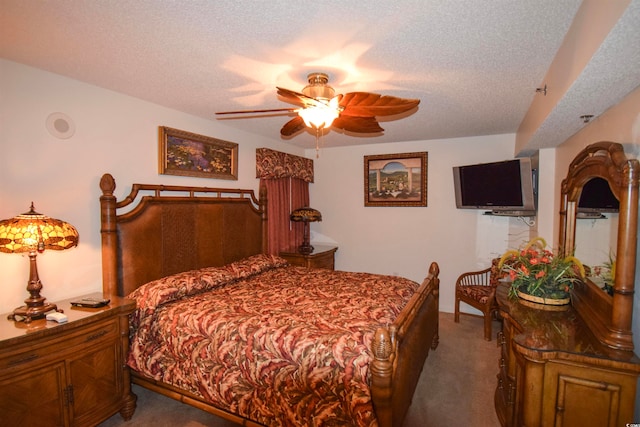 bedroom featuring carpet, ceiling fan, and a textured ceiling