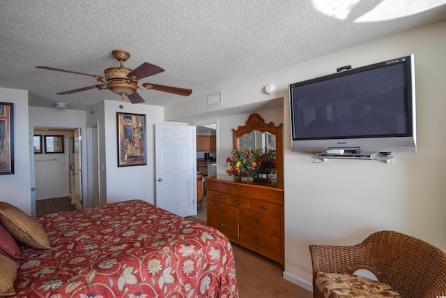 bedroom with visible vents, a textured ceiling, carpet flooring, and a ceiling fan