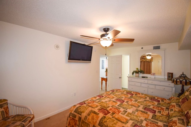 bedroom featuring visible vents, carpet flooring, a textured ceiling, and baseboards