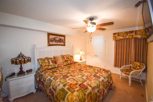 carpeted bedroom with a textured ceiling and ceiling fan