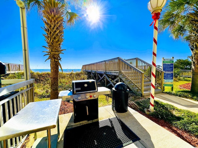 view of patio featuring area for grilling and stairs