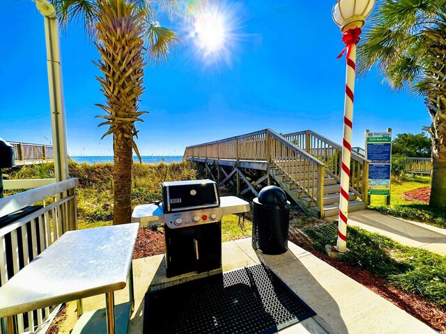 1625 S Ocean Blvd S Unit 910, North Myrtle Beach, SC 29582 - view of patio featuring area for grilling and stairs