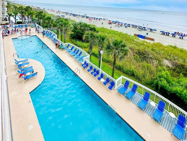 community pool with a beach view and a water view