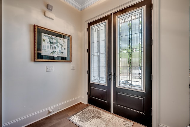 foyer entrance with baseboards, ornamental molding, dark wood-type flooring, and french doors