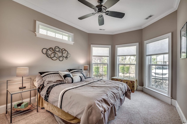 bedroom featuring ornamental molding, carpet, visible vents, and multiple windows