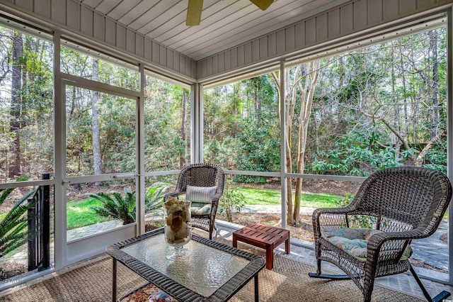 sunroom / solarium featuring ceiling fan