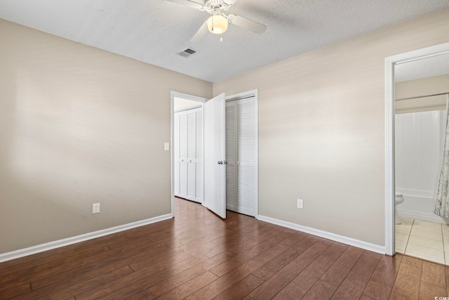 unfurnished bedroom featuring wood finished floors, visible vents, and baseboards