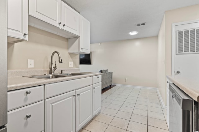 kitchen with dishwasher, white cabinets, a sink, and light countertops