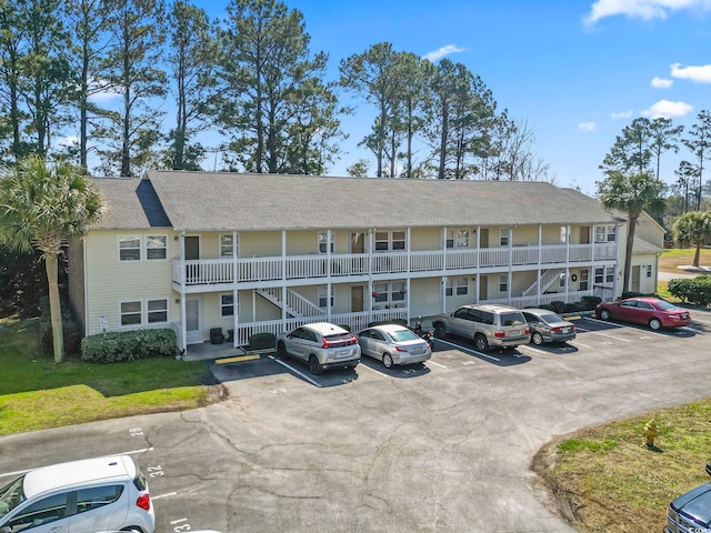 view of building exterior with uncovered parking