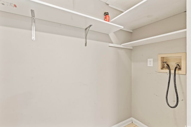 laundry area featuring laundry area, washer hookup, and baseboards