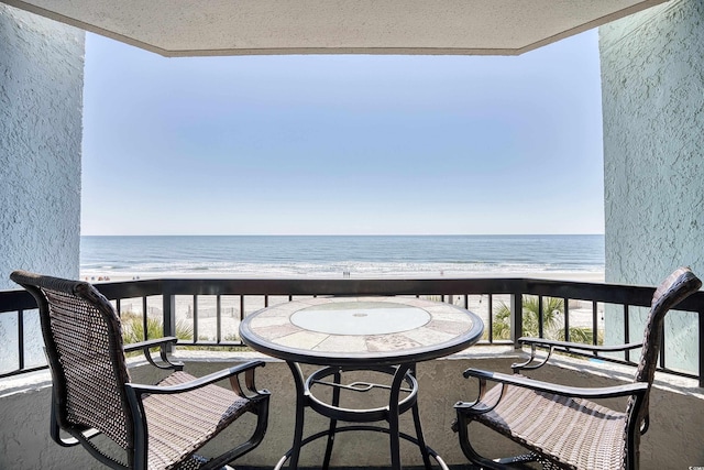 balcony with a beach view and a water view