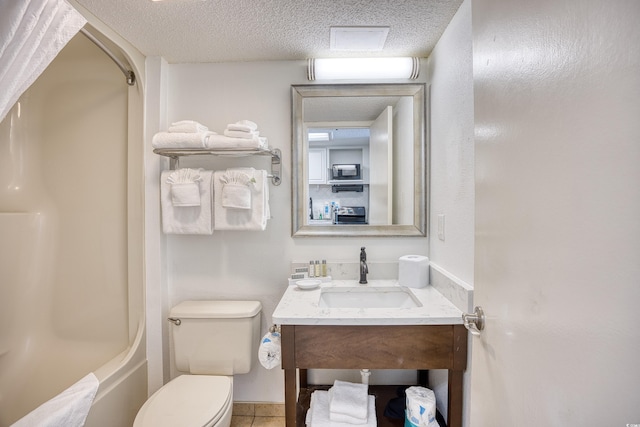 full bathroom featuring a textured ceiling, bathing tub / shower combination, vanity, and toilet