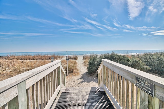 surrounding community with a water view and a view of the beach