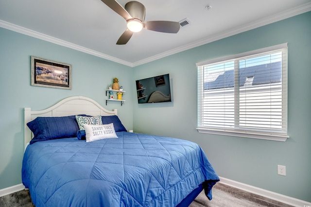 bedroom featuring ornamental molding, visible vents, baseboards, and a ceiling fan