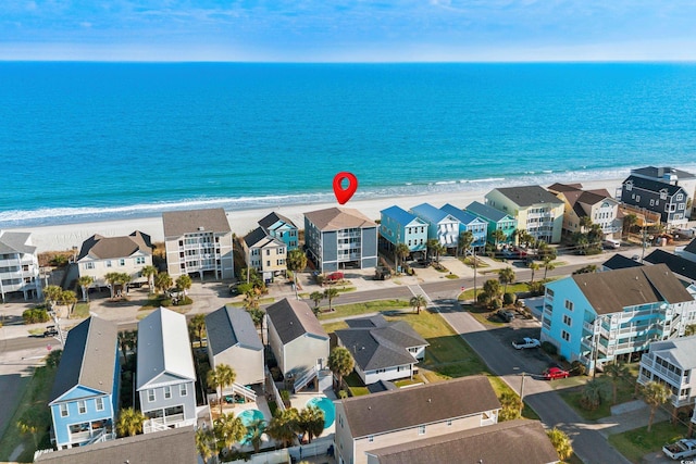 bird's eye view with a water view, a residential view, and a beach view