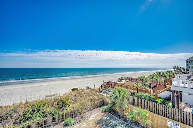 property view of water with fence and a beach view