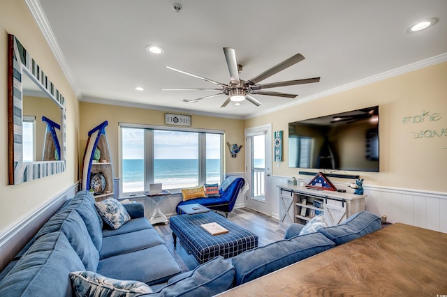 living room with ornamental molding, recessed lighting, a wainscoted wall, and wood finished floors