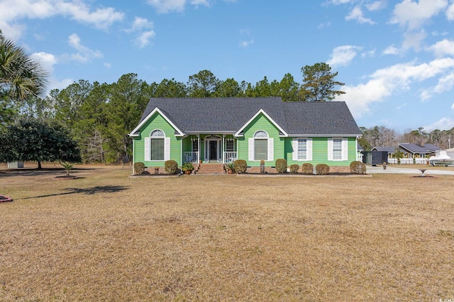 ranch-style house featuring a front yard and covered porch