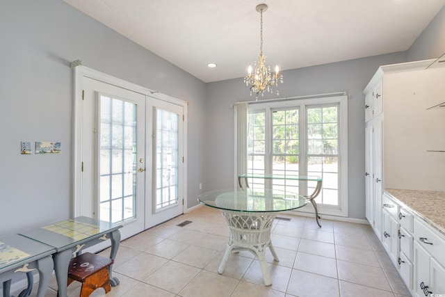 dining space with light tile patterned floors, french doors, visible vents, and baseboards