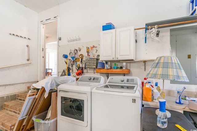 clothes washing area with cabinet space and washing machine and dryer