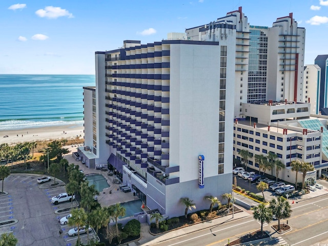 drone / aerial view featuring a beach view and a water view