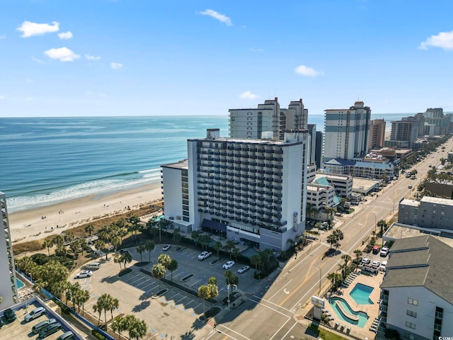 aerial view featuring a view of city, a water view, and a beach view