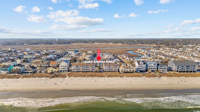 bird's eye view with a view of the beach, a water view, and a residential view