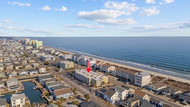 aerial view with a water view and a beach view