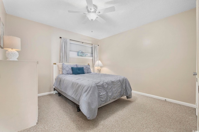 bedroom featuring a textured ceiling, carpet floors, a ceiling fan, and baseboards