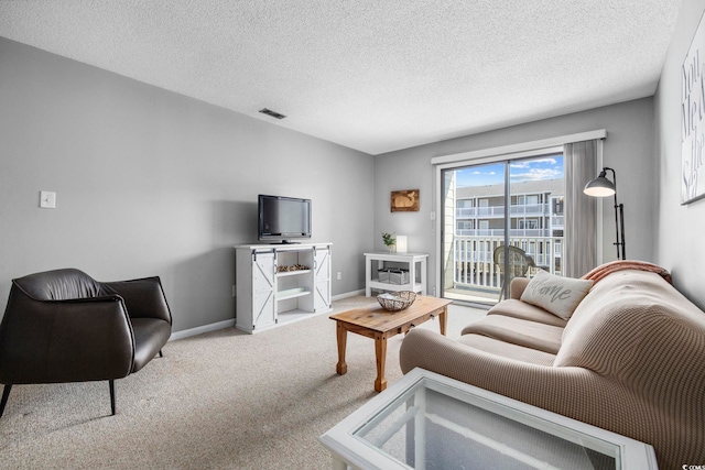 living area featuring carpet, a textured ceiling, visible vents, and baseboards