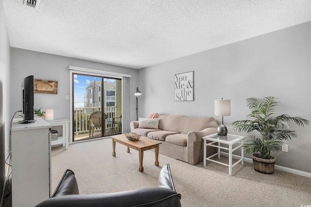 living area with carpet floors, visible vents, baseboards, and a textured ceiling