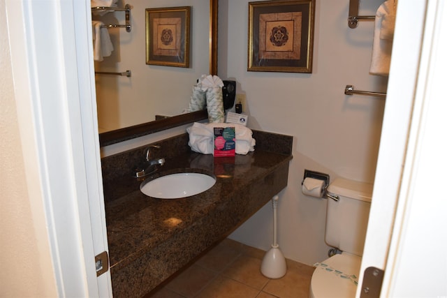 bathroom featuring a sink, toilet, and tile patterned floors